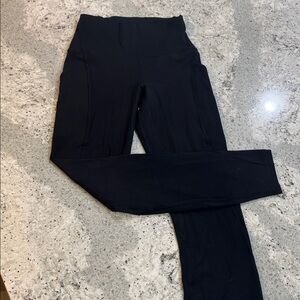 Black Lululemon High-Waisted Leggings w/ pockets on the side.